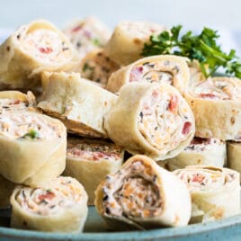 Taco tortilla roll ups on a blue platter.