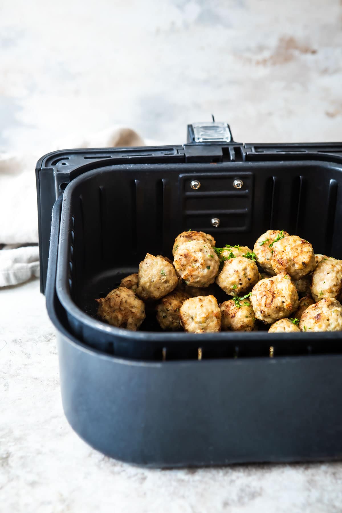 Meatballs in an air fryer.