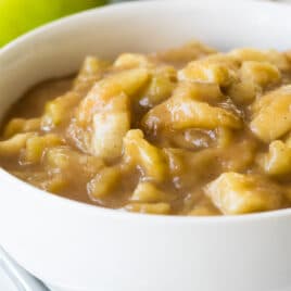 Apple pie filling in a white bowl.