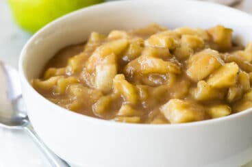 Apple pie filling in a white bowl.
