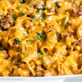 Beef noodle casserole in a white baking dish.
