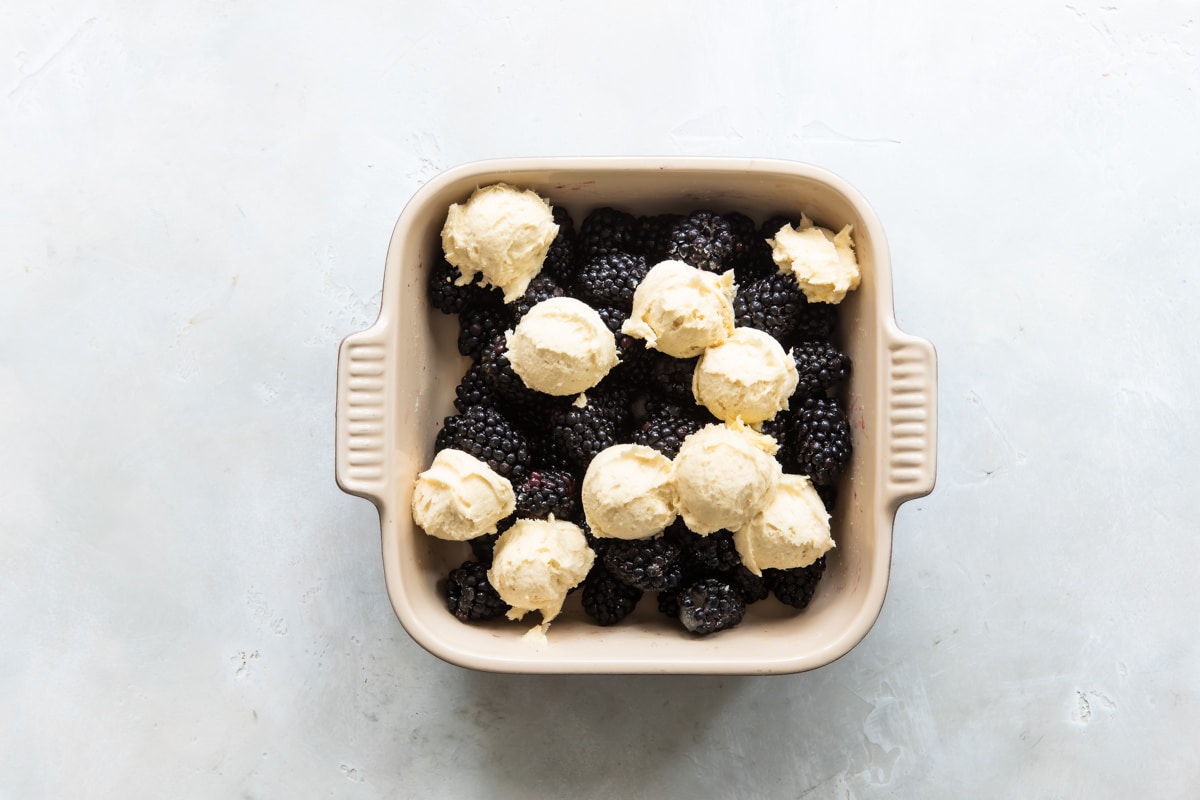 An unbaked baking dish of blackberry cobbler.