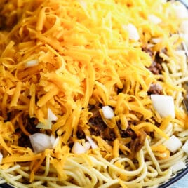 Cincinnati chili in a black and white serving dish.