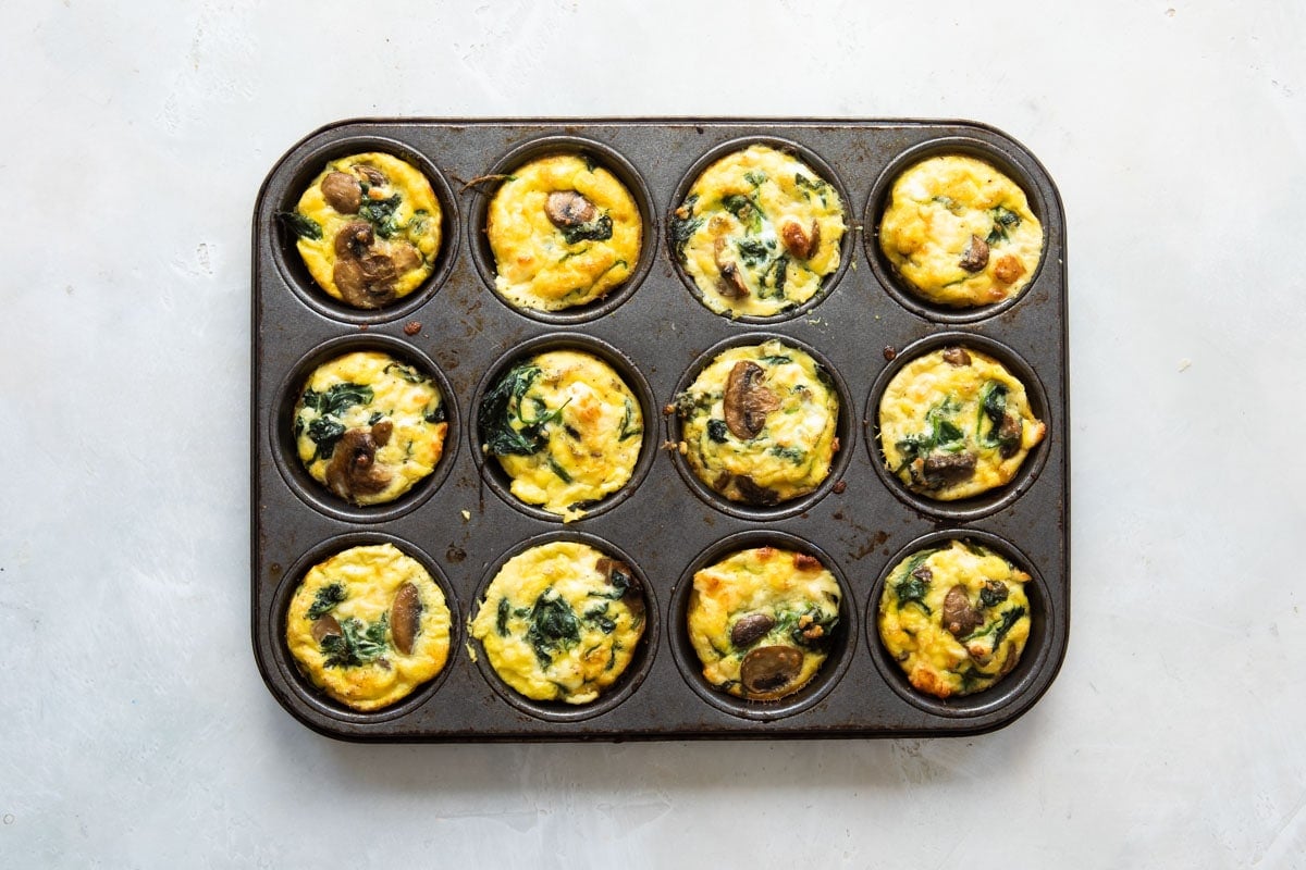 Egg muffins after being baked in a muffin tin.