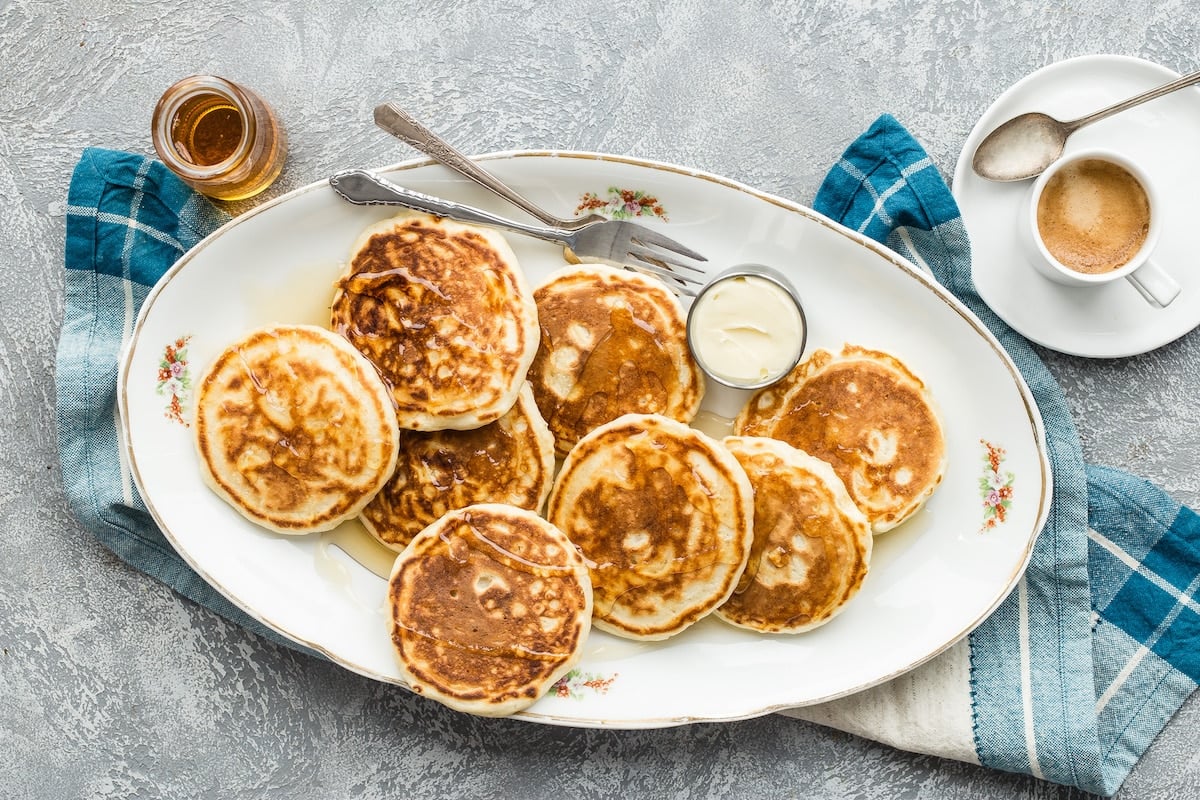 A stack of homemade pancakes on a plate.