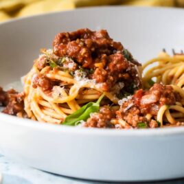 Spaghetti with sauce in a white bowl.