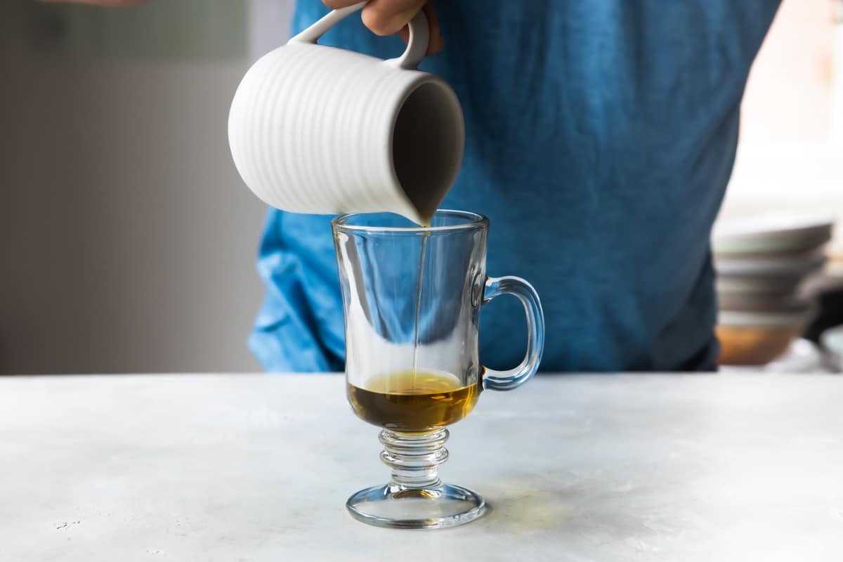 Making Irish coffee in a glass.