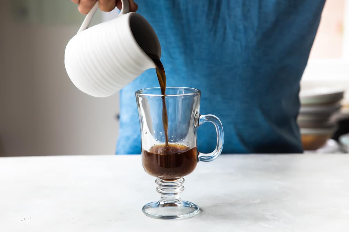 Making Irish coffee in a glass.
