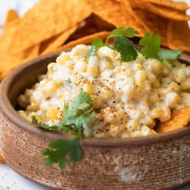Mexican corn salad in a brown bowl.