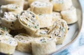 Mexican Tortilla roll ups on a serving platter.