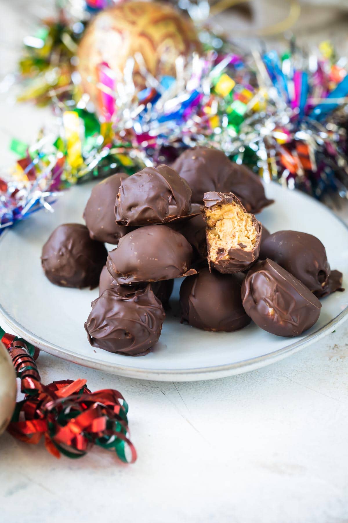 No bake peanut butter balls on a white plate.