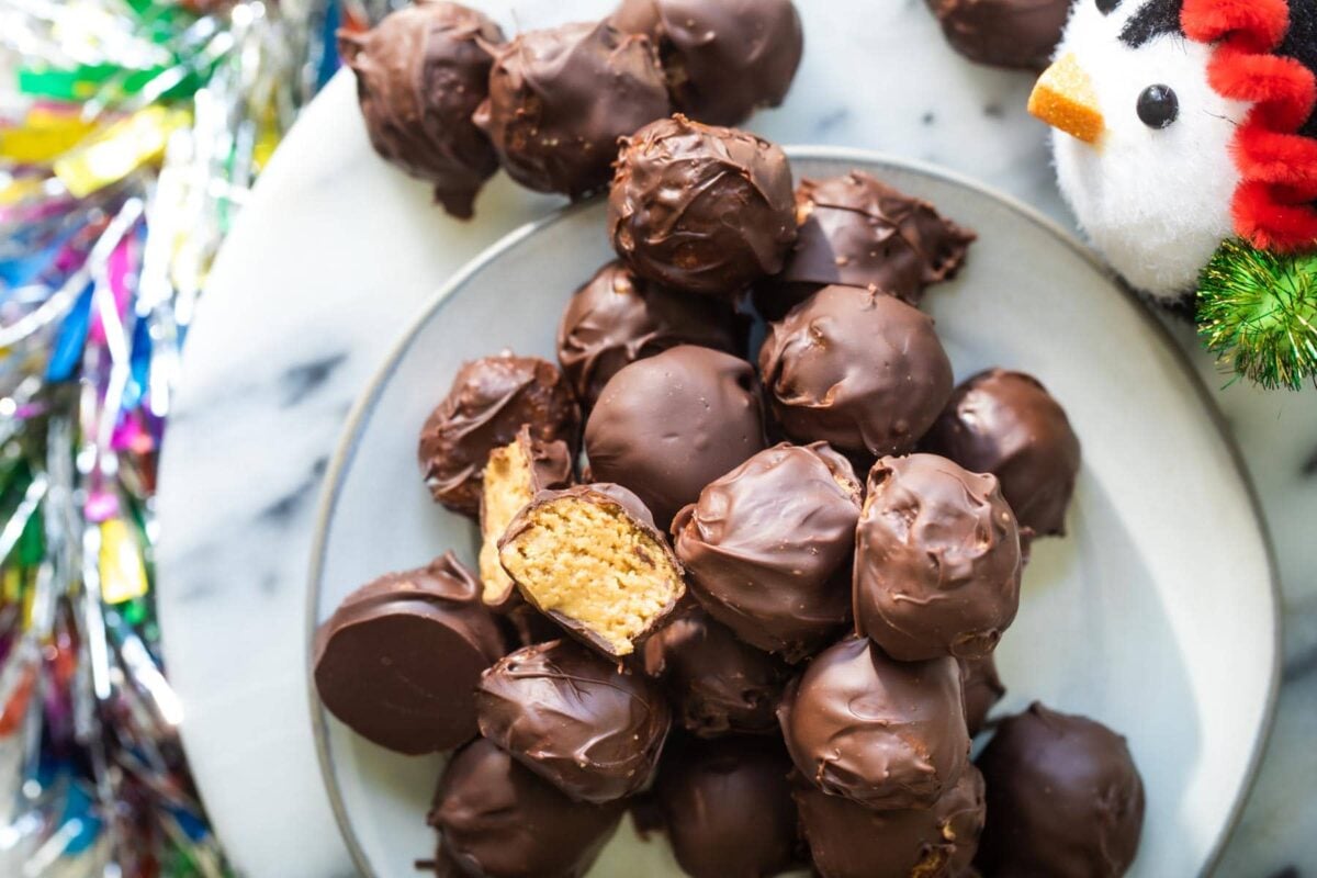 No bake peanut butter balls on a white plate.
