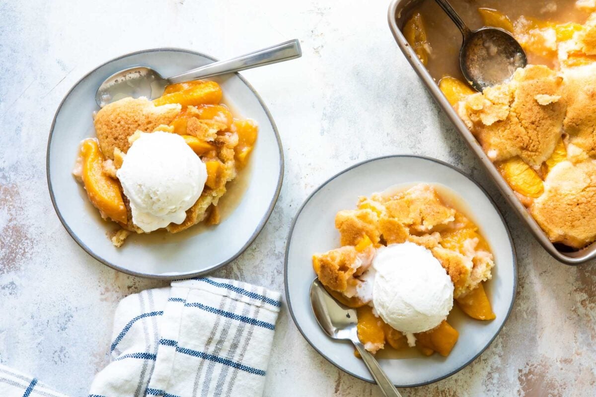 A plate of peach cobbler with vanilla ice cream.
