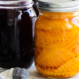 Pickled beets in two mason jars.