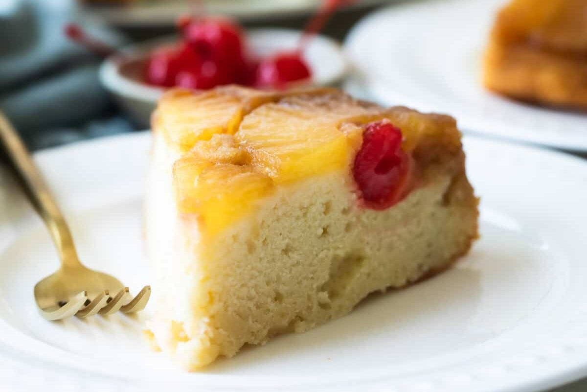 A slice of pineapple upside down cake on a plate.