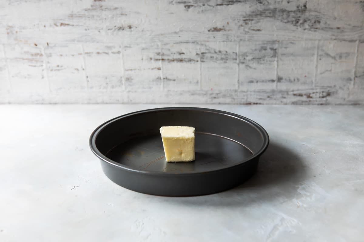 A piece of butter in a cake pan.