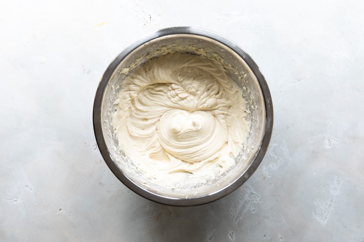 Pineapple upside down cake batter in a silver bowl.