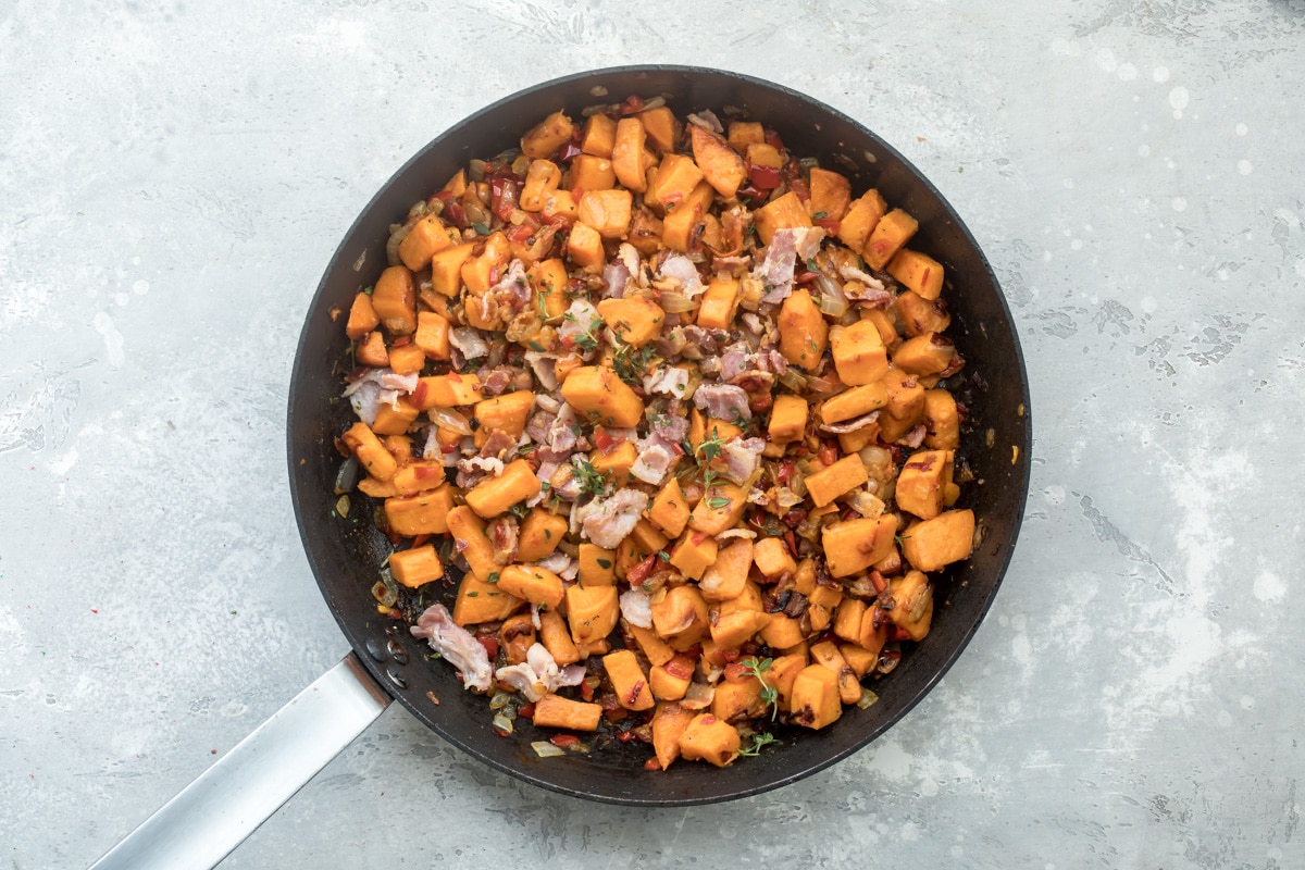 Sweet potato hash in a black skillet.