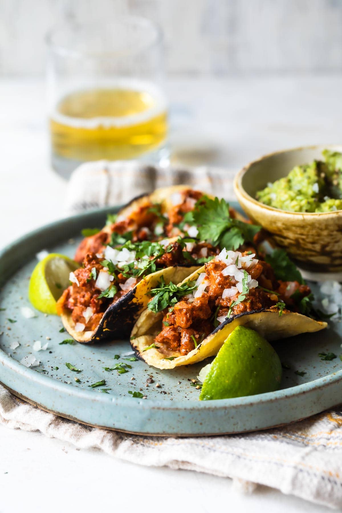 Tacos al pastor on a blue plate.