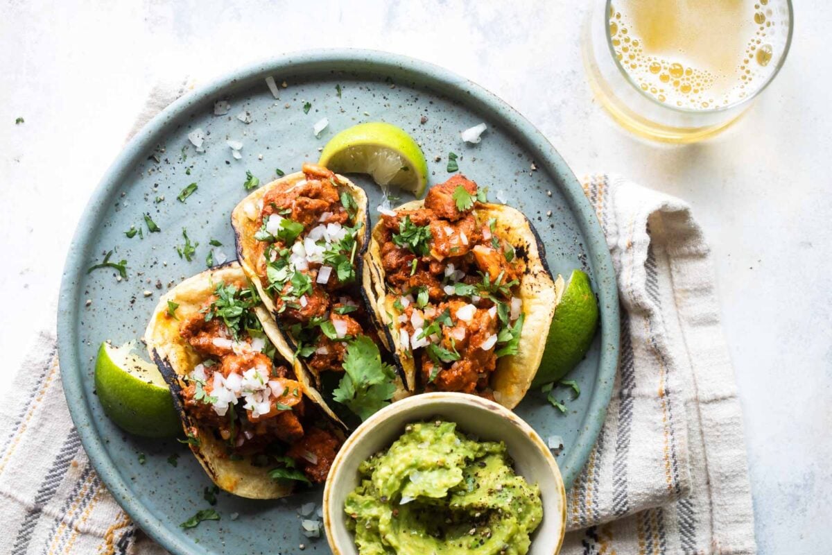 Tacos al pastor on a blue plate.