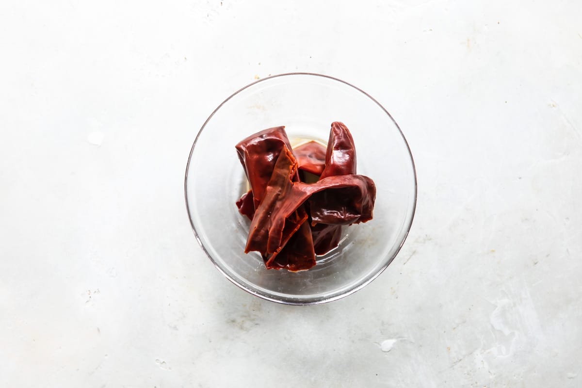 Dried chiles soaking in water.