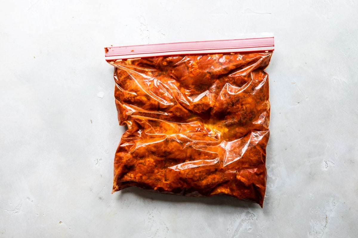 Pork marinating in achiote paste and chiles.