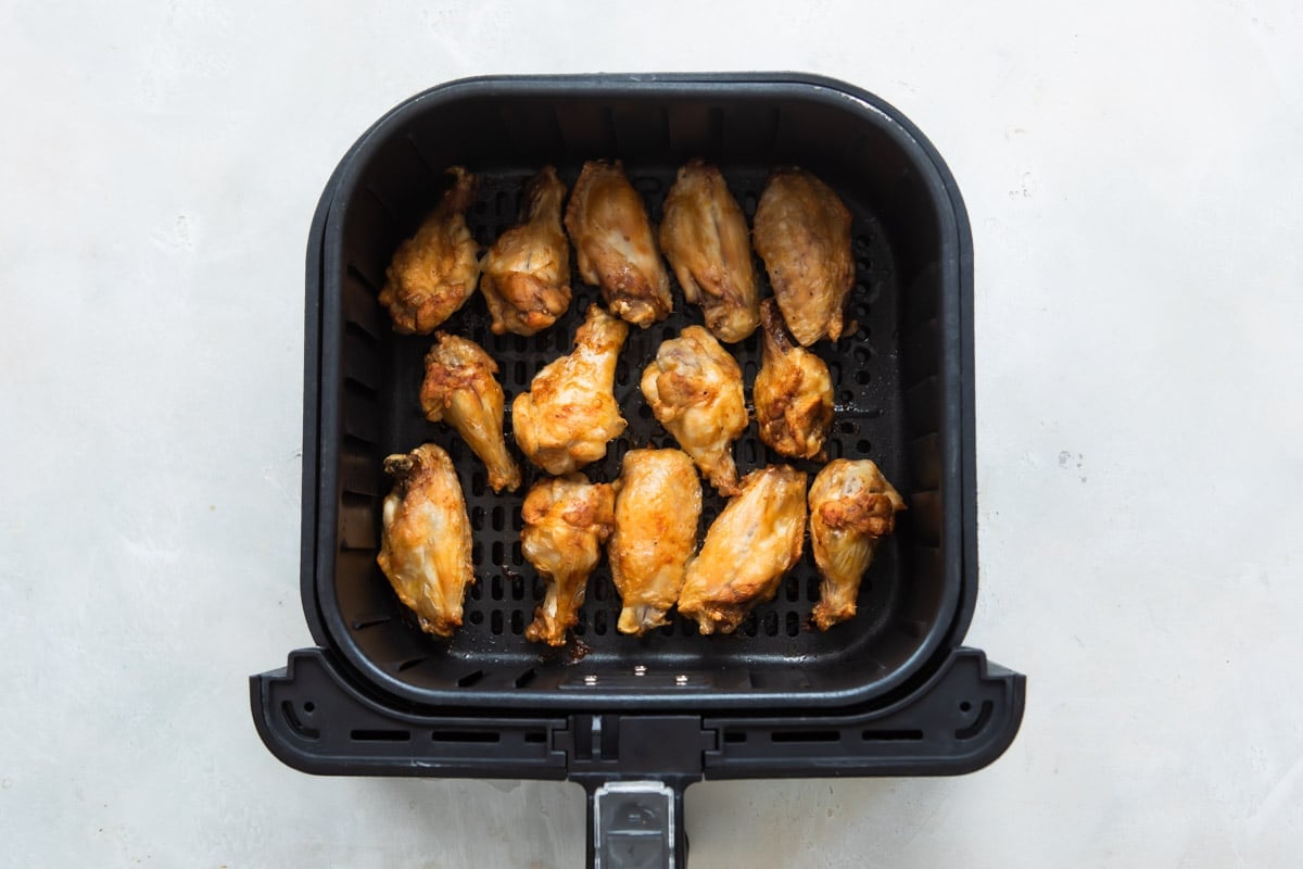 Air fryer chicken wings in an air fryer.