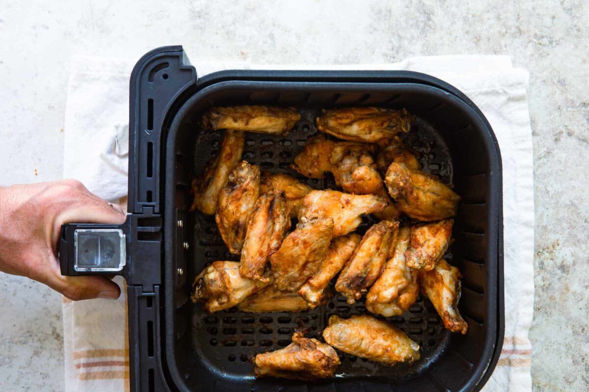 Air fryer chicken wings in an air fryer.