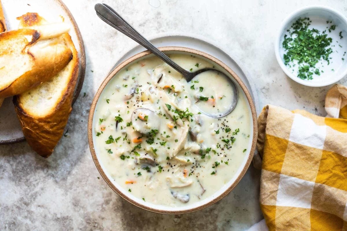 Chicken wild rice soup in a bowl with a spoon.