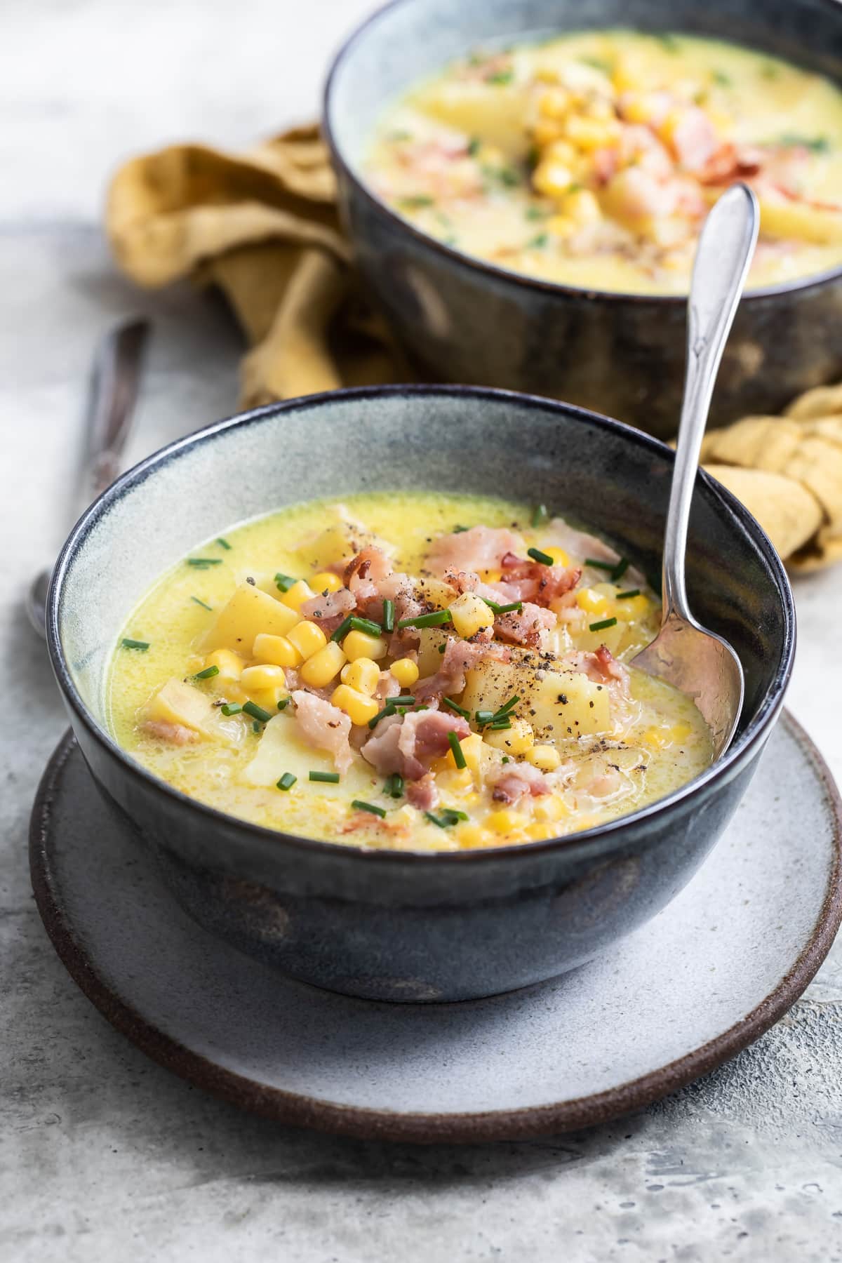 Corn chowder in a blue bowl.