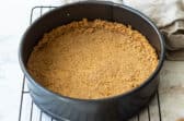 A graham cracker crust in a springform pan.