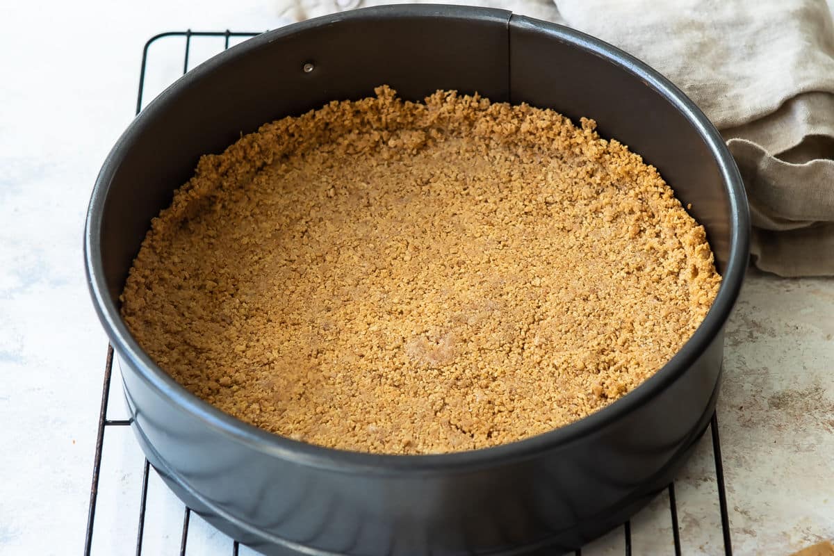 A graham cracker crust in a springform pan.