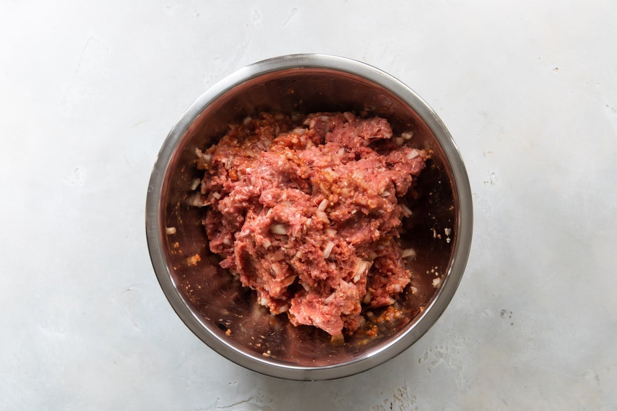 Meatloaf mixture in a silver bowl.