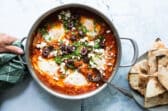 Shakshouka in a silver pan.