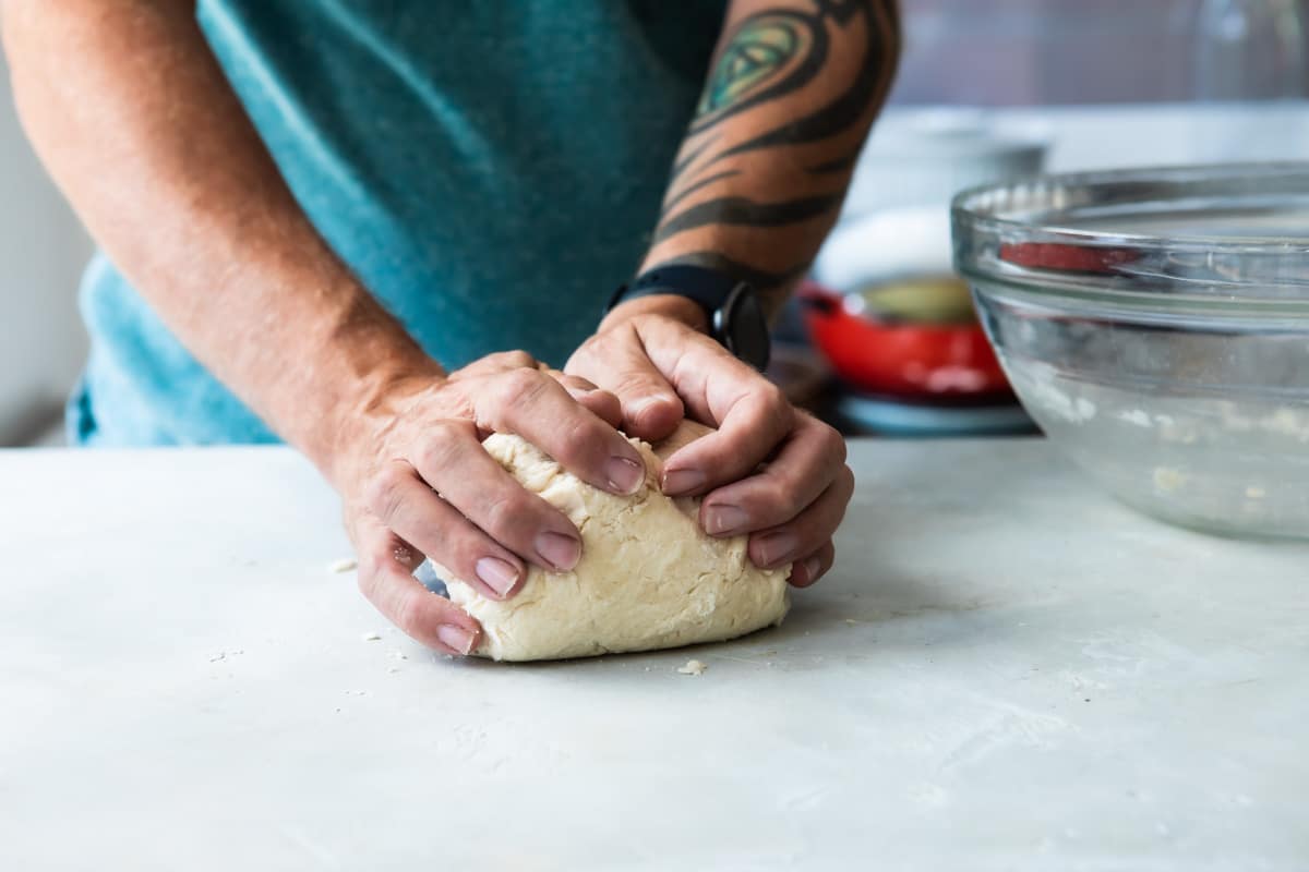 Someone kneading biscuit dough.