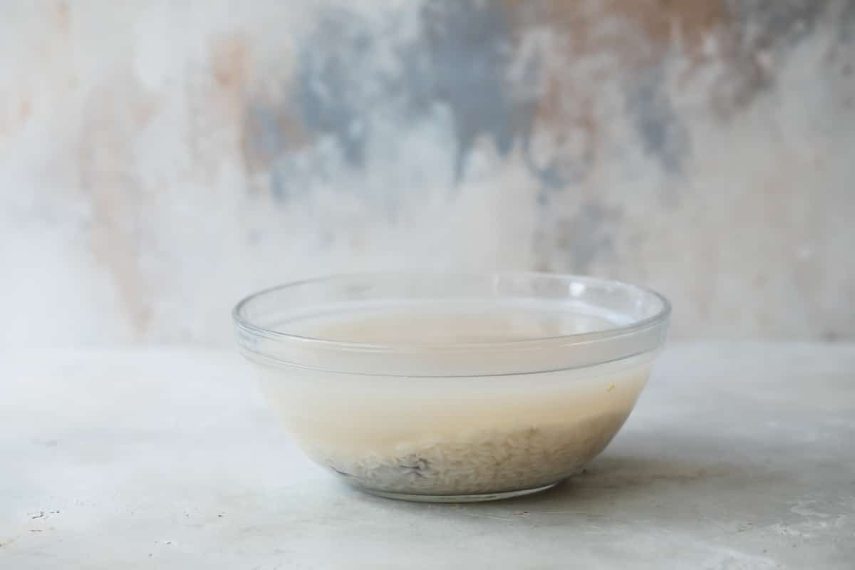 Soaking rice and cinnamon in water to make horchata.