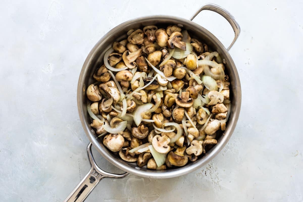 A skillet of mushrooms and onions.