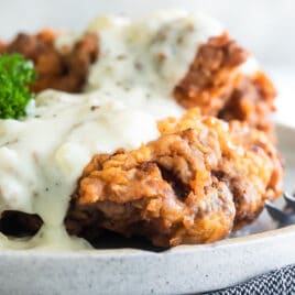Chicken fried steak on a platter.