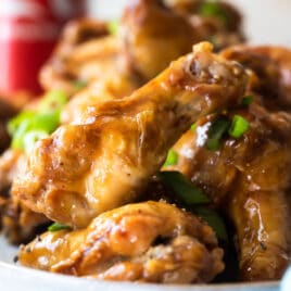 Coca Cola chicken wings on a white platter.
