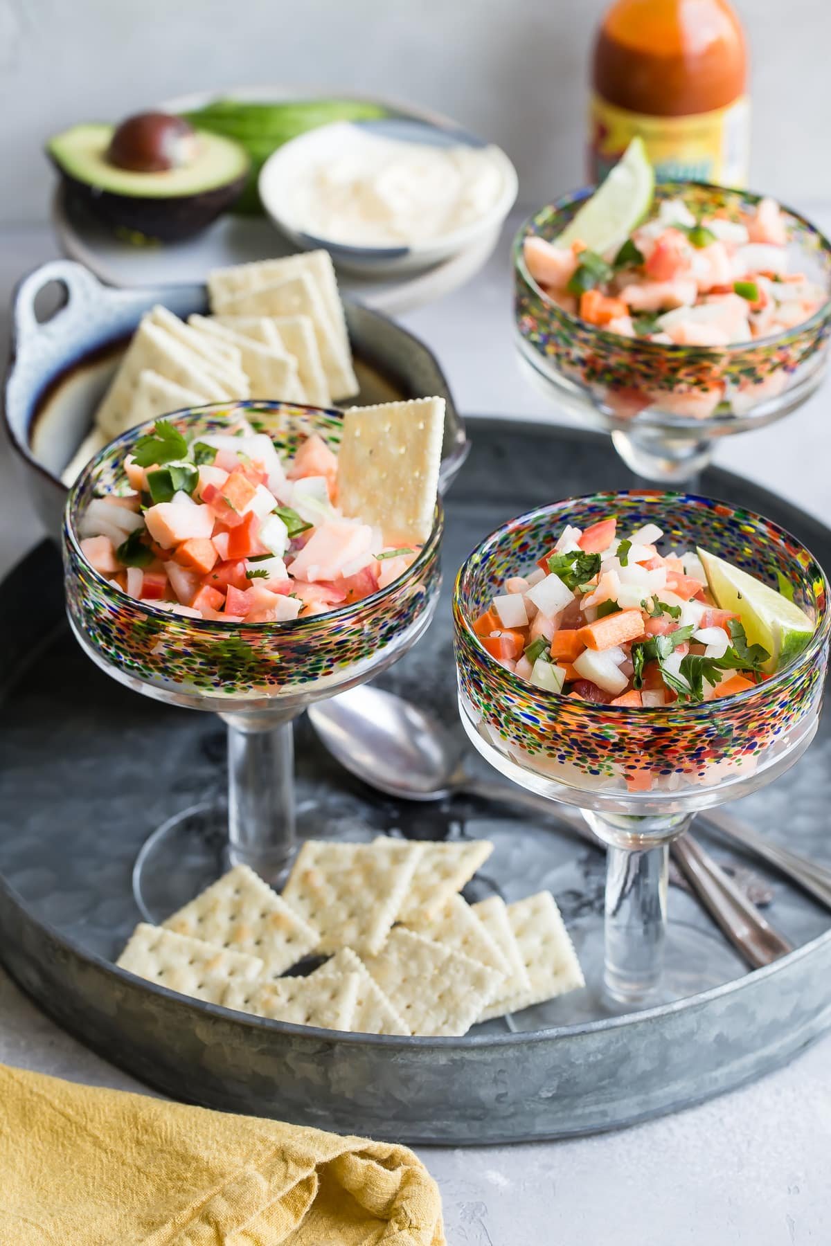 An angled shot of salmon ceviche in stemmed glasses.