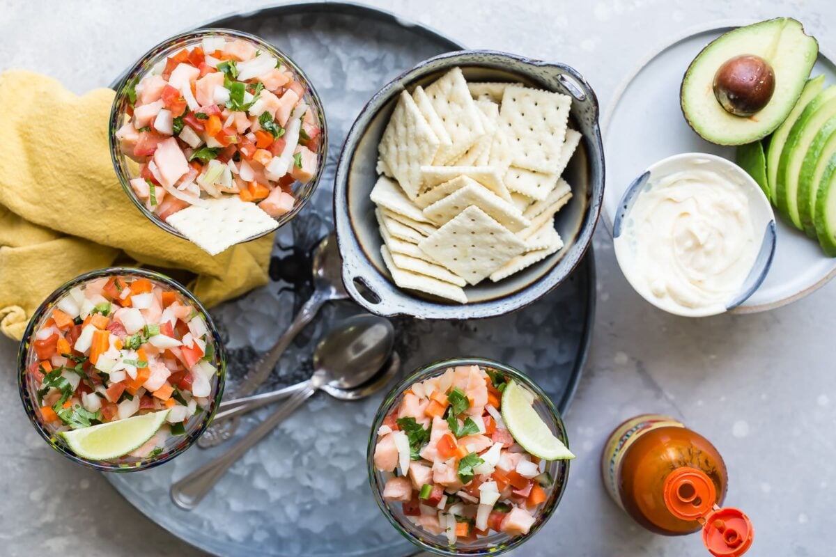 An overhead shot of salmon ceviche in stemmed glasses.