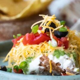 Seven layer dip on a blue platee.