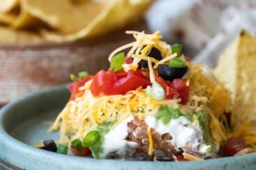Seven layer dip on a blue platee.