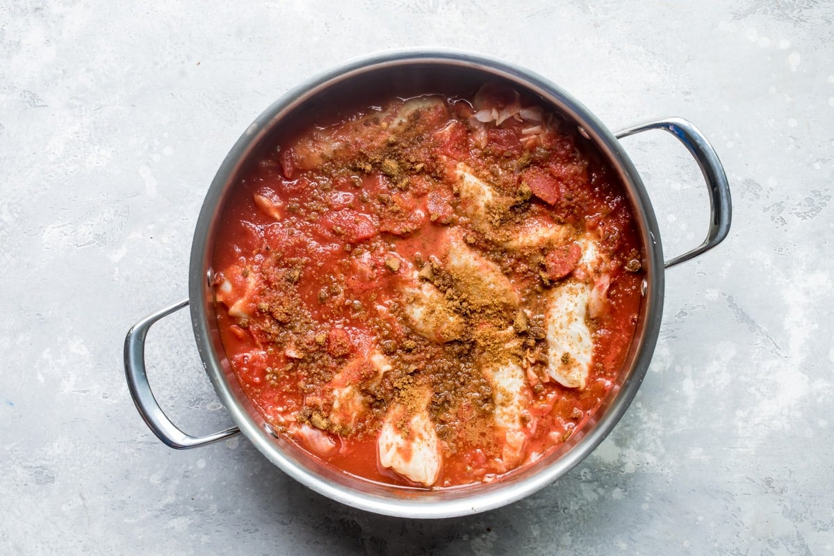 Stuffed cabbage rolls in a silver pot.