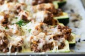 Stuffed zucchini on a baking sheet.
