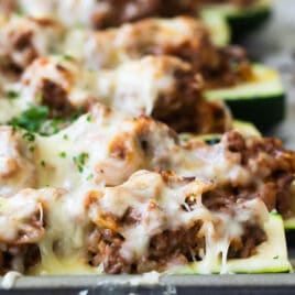 Stuffed zucchini on a baking sheet.