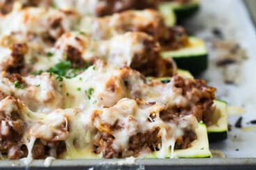 Stuffed zucchini on a baking sheet.