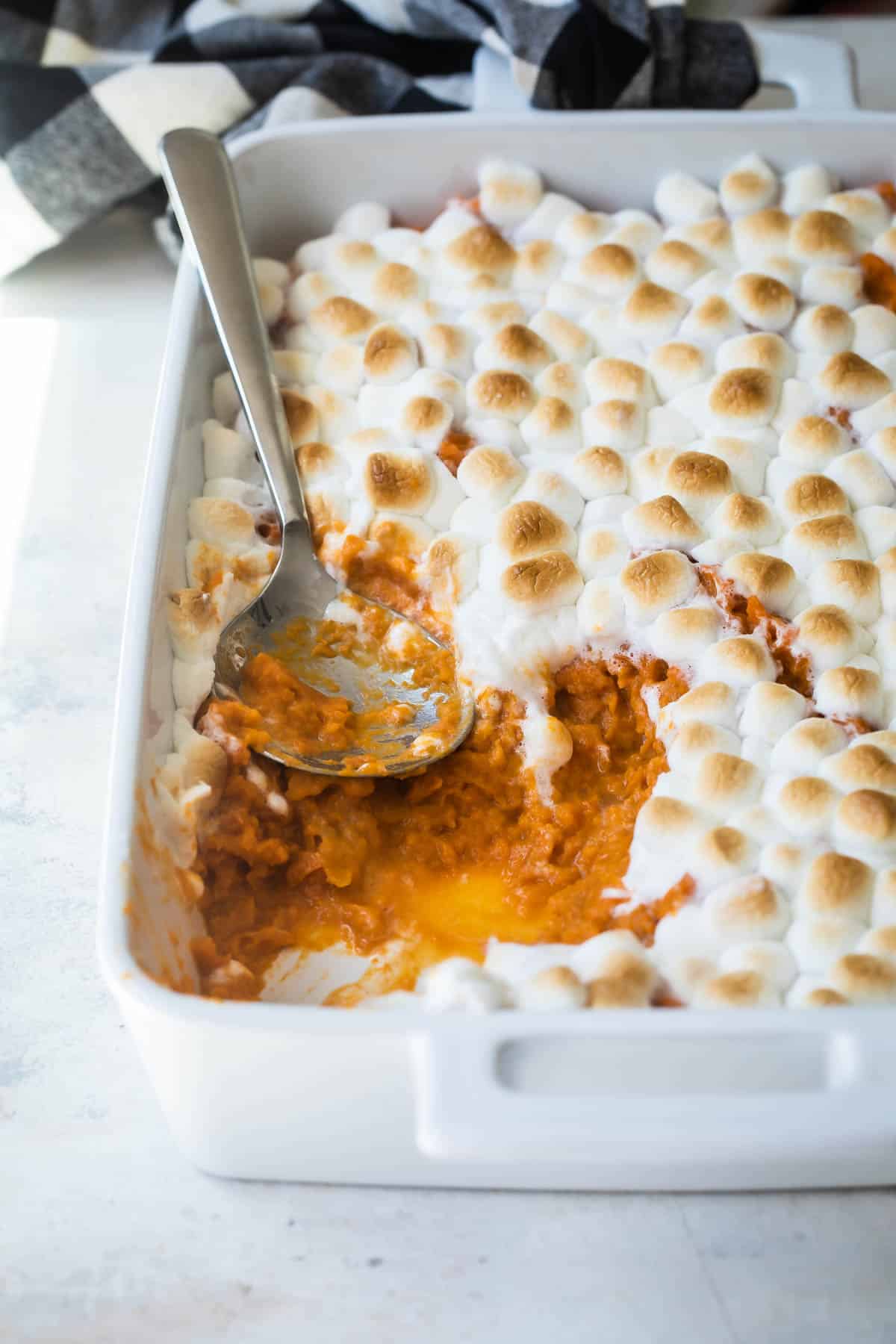 Sweet potato casserole in a white casserole dish.