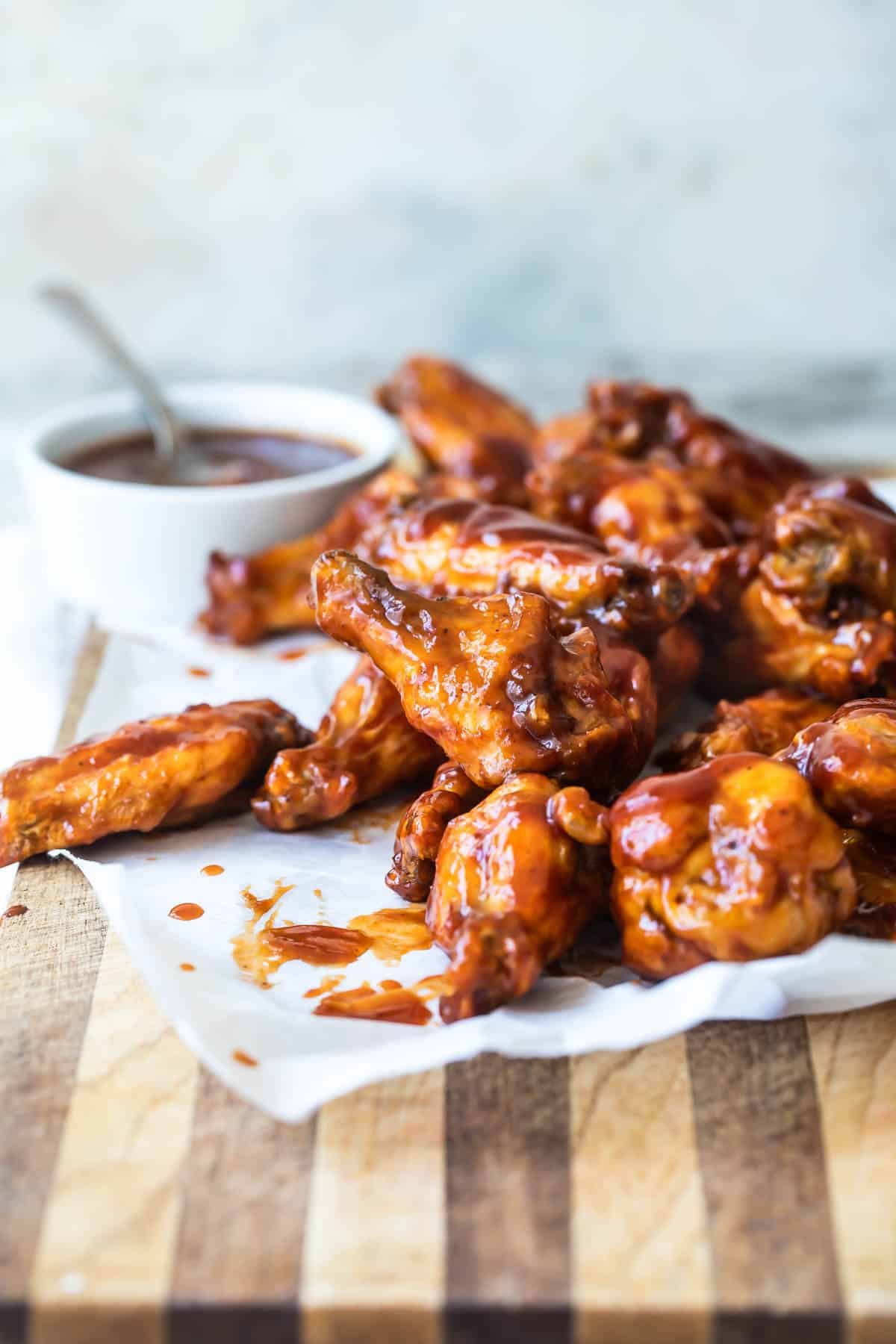 A plate of air fryer chicken wings in barbecue sauce.