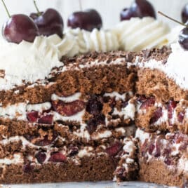 A black forest cake on a marble platter.